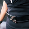 Woman wearing a black dress while wearing a branded Laurice Noire LN Logo belt with Silver Hardware.