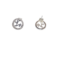 Pair of silver earrings with circular designs on a white background