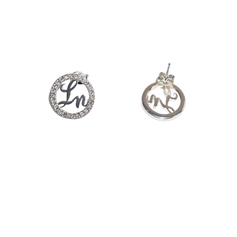 Pair of silver earrings with circular designs on a white background